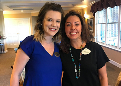 Ashley Woodcox executive director hugging associate